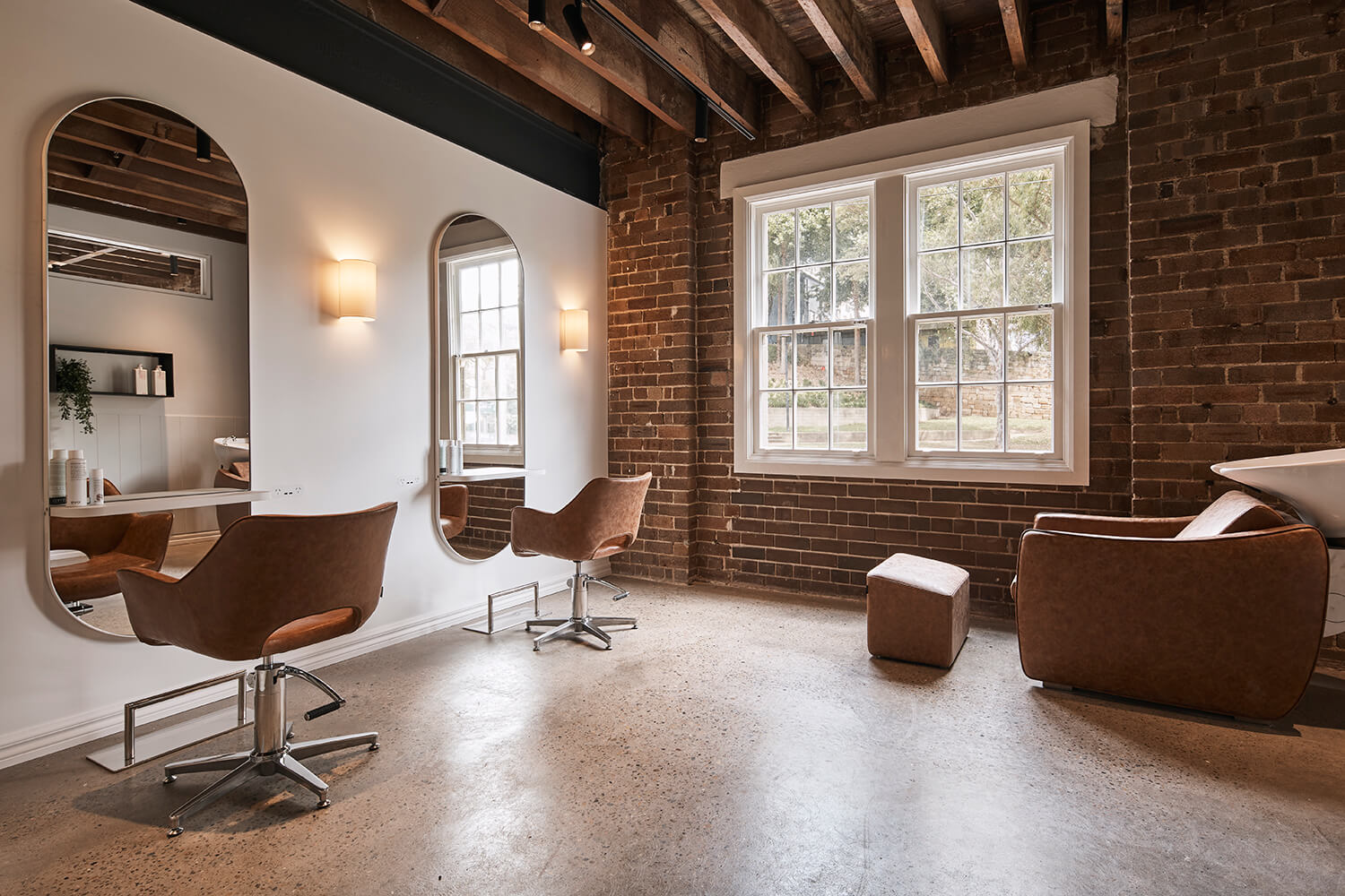 Private hair salon with two chairs, hair wash basin and large window in Salon Lane Surry Hills