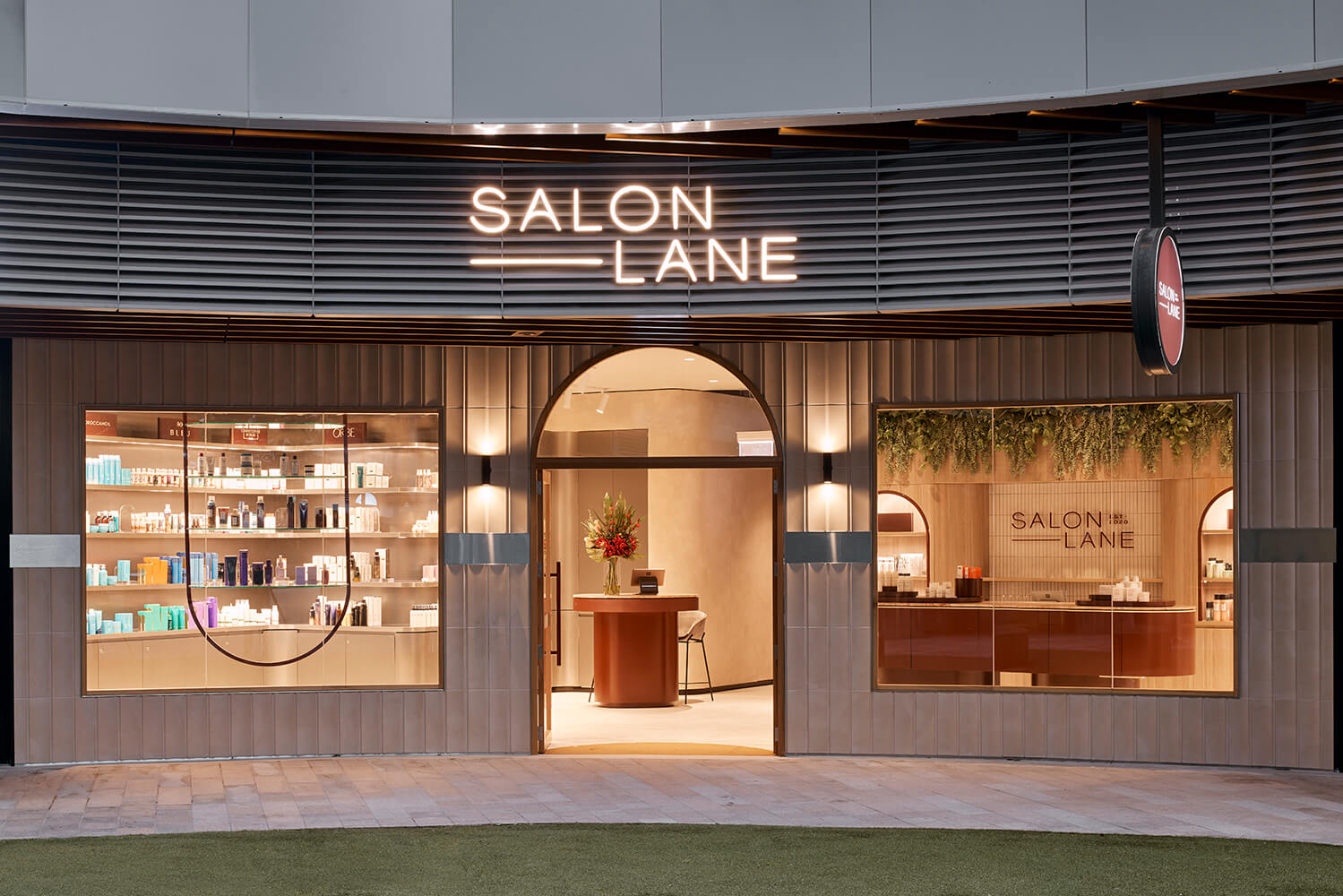 Entrance of Salon Lane in St Leonard Sydney with products and reception desk shown through large windows